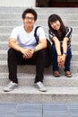 College life is awesome. Portrait of two asian college students sitting on a staircase on campus. Royalty Free Stock Photo