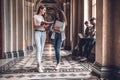 College life.Beautiful students standing together and chatting on the university hall Royalty Free Stock Photo