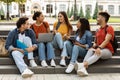 College Lifestyle. Group Of Students Relaxing Together Outdoors In Campus Park Royalty Free Stock Photo