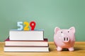 529 college savings plan theme with textbooks and piggy bank