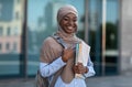 College Scholarships for Muslim Students. Happy Black Islamic Woman With Workbooks Outdoors