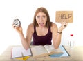 College student girl in stress asking for help holding alarm clock time exam concept Royalty Free Stock Photo