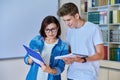 College student guy teenager meeting discussing with teacher mentor in classroom Royalty Free Stock Photo