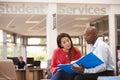 College Student Having Meeting With Tutor To Discuss Work Royalty Free Stock Photo