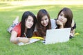 College student lying down on the grass working Royalty Free Stock Photo