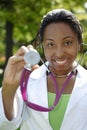 Beautiful female African American college student on campus wearing whitecoat Royalty Free Stock Photo