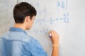 College student solving math equation on white board Royalty Free Stock Photo