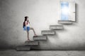 College student on stairs toward door Royalty Free Stock Photo