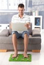 College student using laptop smiling at home Royalty Free Stock Photo