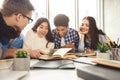 College students in cooperation with their assignment at library Royalty Free Stock Photo