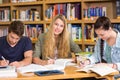 College students doing homework in library Royalty Free Stock Photo