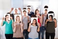 College students holding photographs in front of faces Royalty Free Stock Photo