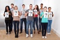 College students holding question mark signs Royalty Free Stock Photo
