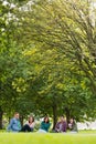 College students sitting in park Royalty Free Stock Photo
