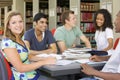 College students studying together in a library Royalty Free Stock Photo