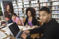 College Students Studying Together In Library