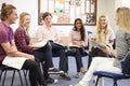 College Students With Tutor Having Discussion Royalty Free Stock Photo