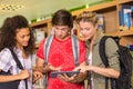 College students using digital tablet in library Royalty Free Stock Photo