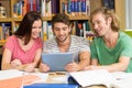 College students using digital tablet in library Royalty Free Stock Photo