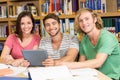 College students using digital tablet in library Royalty Free Stock Photo