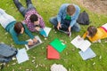 College students using laptop while doing homework in park Royalty Free Stock Photo