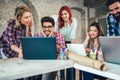 College students using laptop while sitting at table. Royalty Free Stock Photo