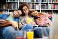 College, study, university and education concept. Group of tired students learning in library Royalty Free Stock Photo