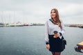 College woman student of Marine academy drinking coffee by sea wearing uniform. Girl walking in seaport of Odesa Royalty Free Stock Photo