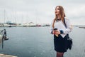 College woman student of Marine academy drinking coffee by sea wearing uniform. Girl walking in seaport of Odesa Royalty Free Stock Photo