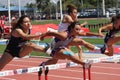 College women jumping hurdles race