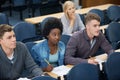 College, writing and students learning with notes in class, auditorium or lecture hall for education. University Royalty Free Stock Photo