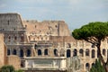 The Coliseum with visitors and the Arch of Titus at the roman forum