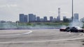 The collision of a drift car on a race track with a fence during the passage of a turn.