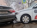 he collision of a white taxi and a black car due to ice.