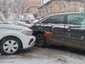 he collision of a white taxi and a black car due to ice.