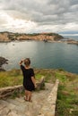 Young blond woman with black dress on the coast of Colliure, France. Royalty Free Stock Photo