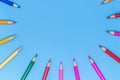 Collor wooden pencils in row  on bluebackground. Royalty Free Stock Photo