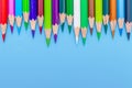 Collor wooden pencils in row isolated on bluebackground. Royalty Free Stock Photo