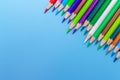 Collor wooden pencils in row isolated on bluebackground. Royalty Free Stock Photo