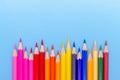 Collor wooden pencils in row isolated on bluebackground. Royalty Free Stock Photo