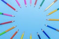 Collor wooden pencils in row isolated on bluebackground. Top view with copy space Royalty Free Stock Photo