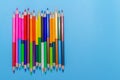 Collor wooden pencils in row isolated on bluebackground