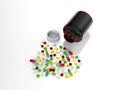 Collorful pills spilled from bottle Royalty Free Stock Photo