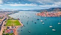 Collorful summer cityscape of Galatas town with public stadium. Splendid morning view of Poros port Royalty Free Stock Photo