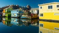 Colorful village of float homes on bright sunny day, blue sky. Royalty Free Stock Photo
