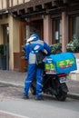 Portrait of dominos pizza delivery man with scooter in the street