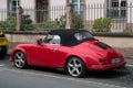 Profile view of red pgo roadster car parked in the street