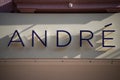 Andre logo on the signboard on shoes store front in the street