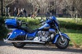 Profile view of blue indian custom motorbike parked in the street Royalty Free Stock Photo