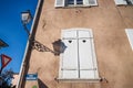 Colmar, France. October 14, 2018. Lantern and its shadow on a wall. Shutters with a hearts. Details